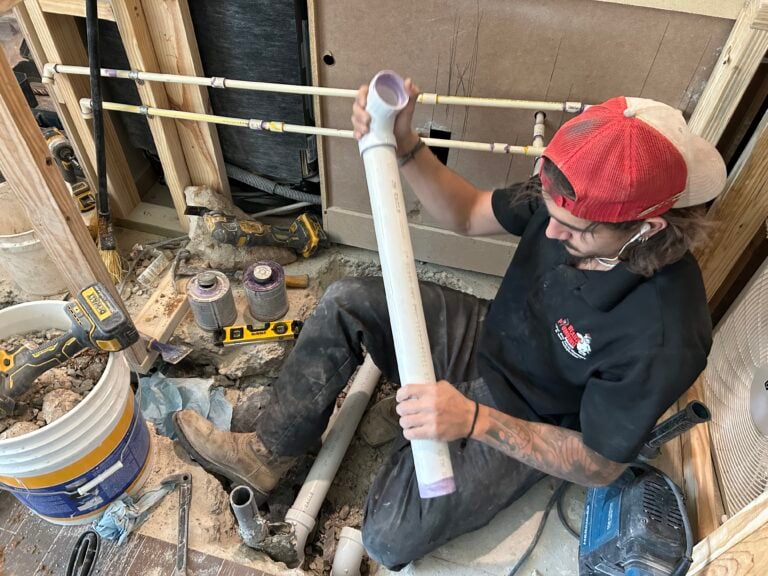 Bear’s Plumbing technician repairing plumbing in a customer’s home
