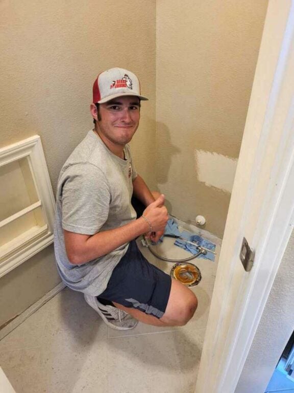 Clayton aka Cub, Bear’s Plumbing technician, installing a toilet while leaving the space clean in Spring, TX