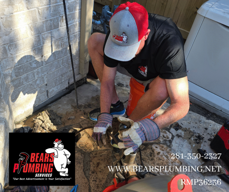 Bear from Bear’s Plumbing operating a sewer machine to clear a residential sewer line blockage in Spring, Texas, demonstrating over 30 years of plumbing experience and hands-on leadership.
