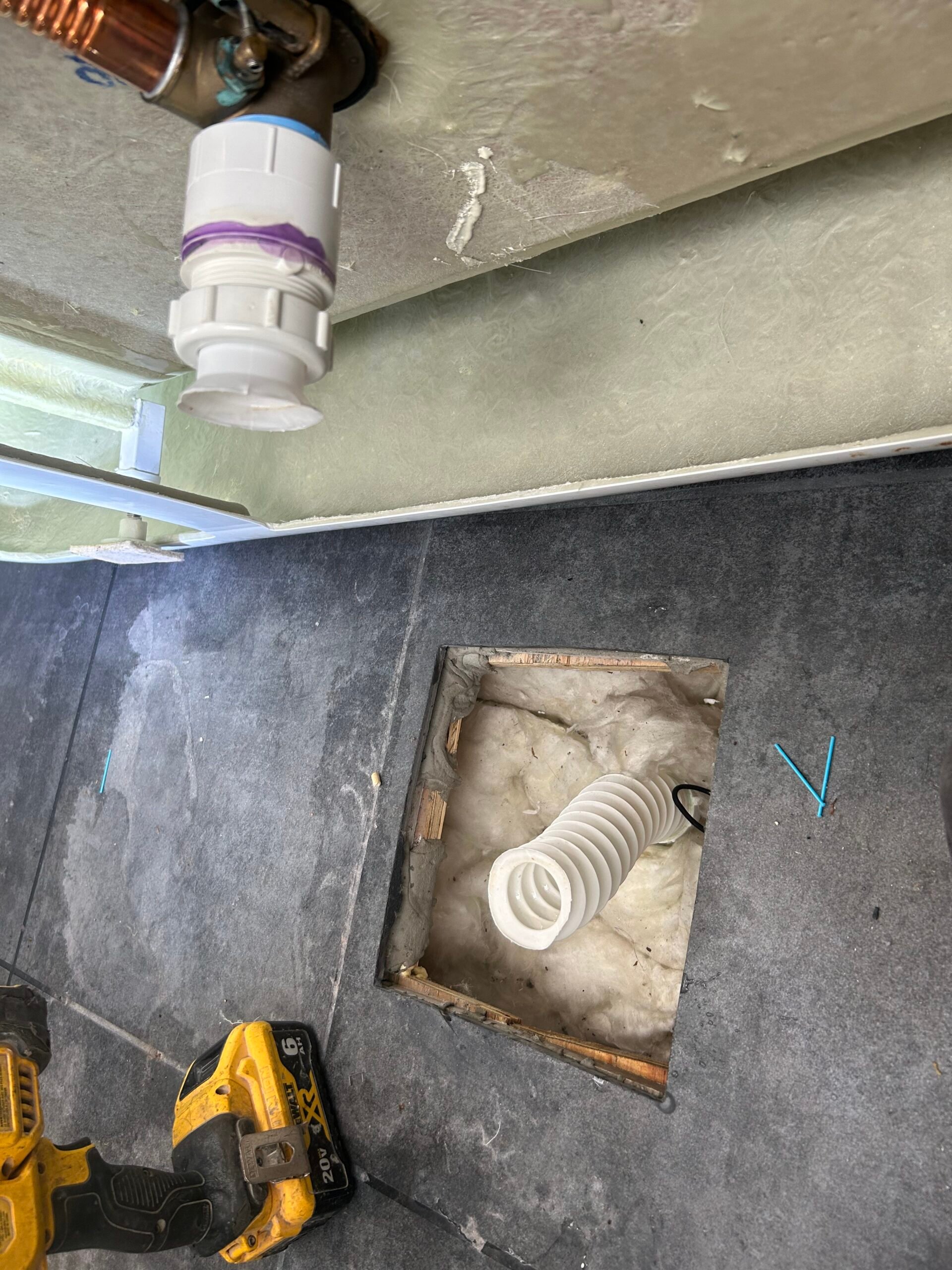 Improper accordion drain installed under a freestanding tub, later corrected with a code-compliant drain by Bear’s Plumbing in Spring, Texas.