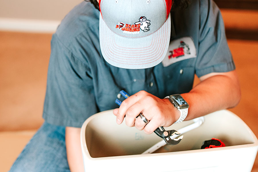 Plumber performing plumbing maintenance in Spring TX