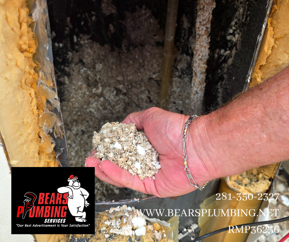 Bear, owner of Bear’s Plumbing in Spring, Texas, holding heavy calcium and mineral buildup removed from a 20-year-old water heater caused by hard water deposits.