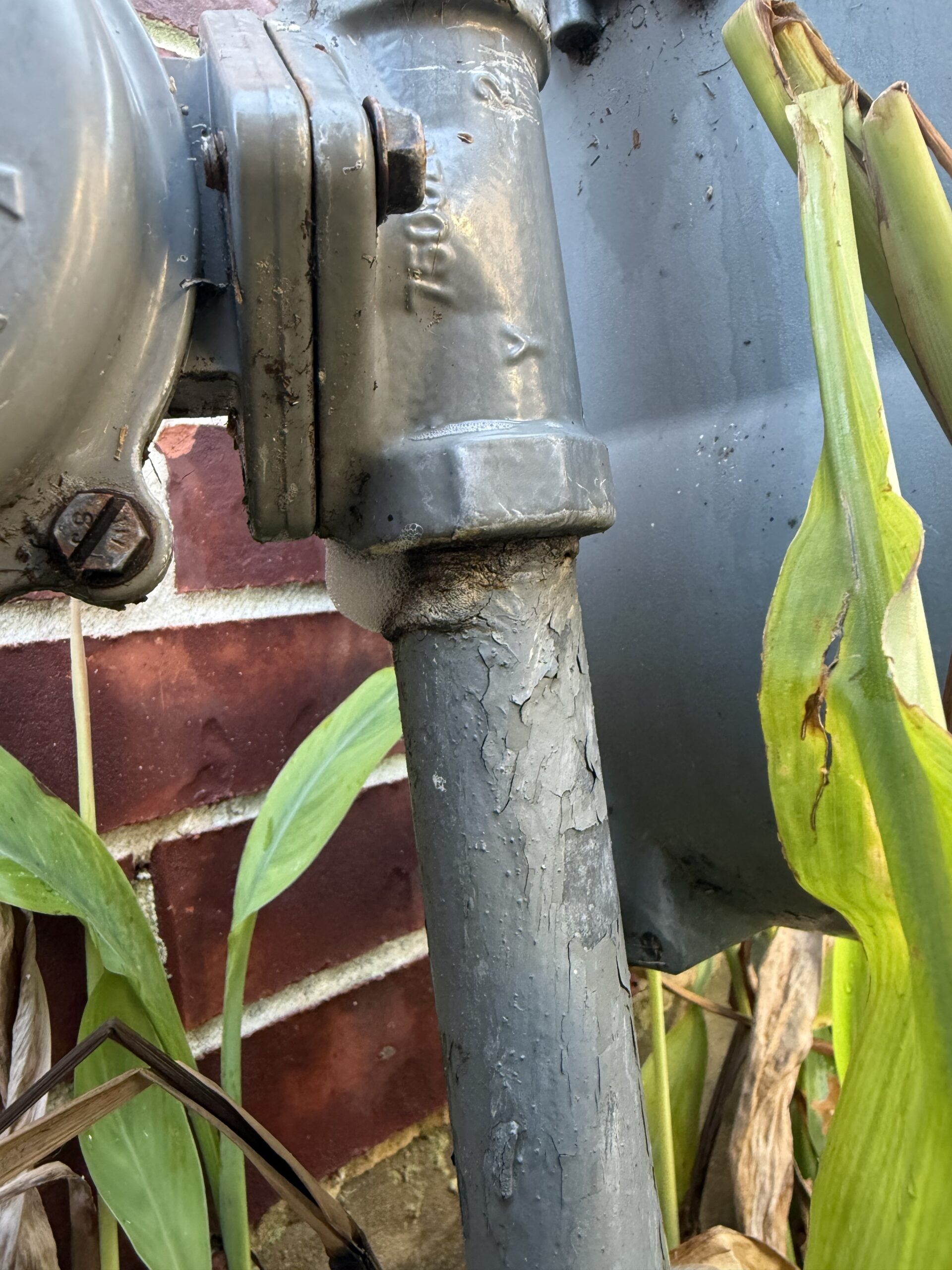 Natural gas meter leaking outside a home in Spring, Texas, being inspected for safety by Bear’s Plumbing Services.