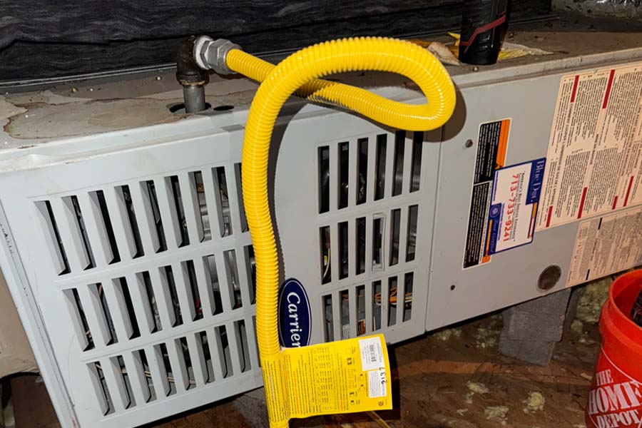 Plumbing inspection checking a gas line near an HVAC unit in Spring TX
