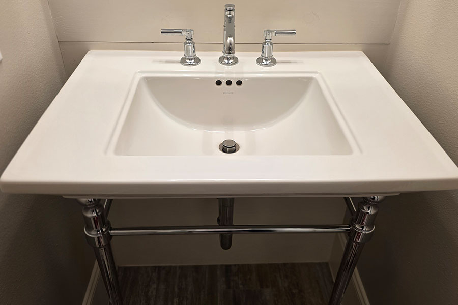 Modern bathroom sink with new faucet installed in Spring TX