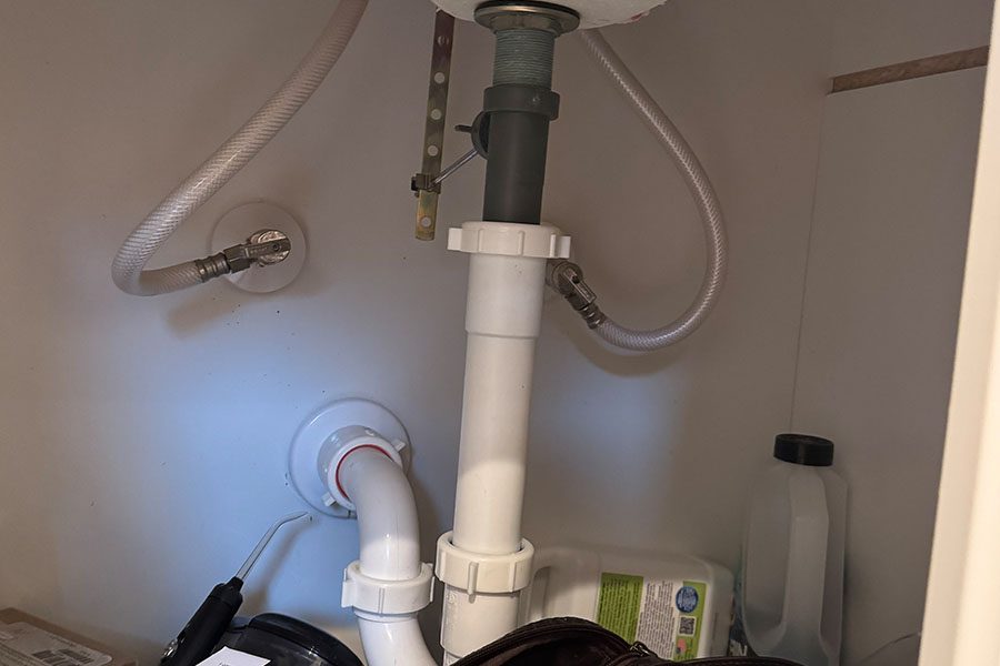 Under sink plumbing checked during maintenance in Spring TX