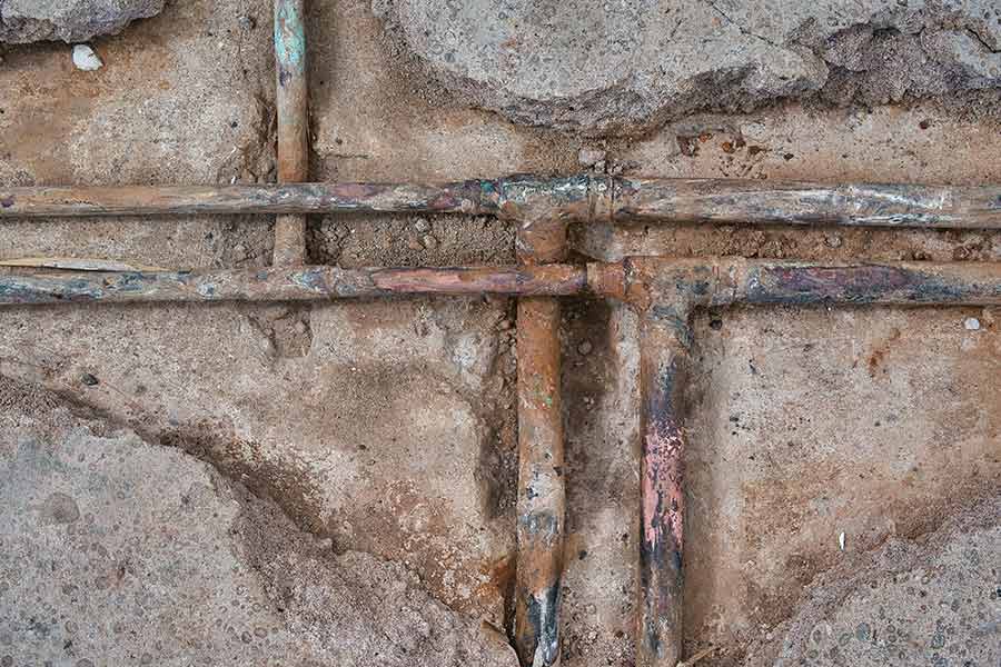 Exposed copper plumbing lines during slab leak detection