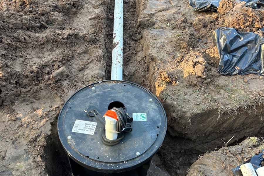 New sump pump and drainage pipe installed below ground